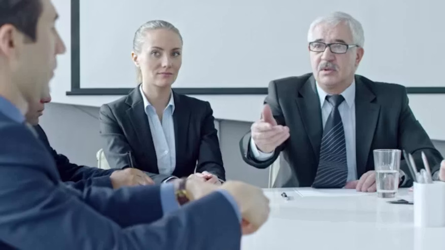 Professionals reviewing contracts, documents and obligations through a controlled process.